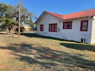 view of side of home featuring a yard