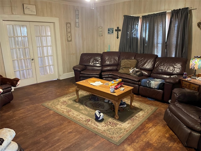 living room featuring dark hardwood / wood-style floors, ornamental molding, and french doors