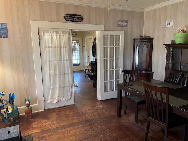 dining area with crown molding, dark wood-type flooring, and french doors