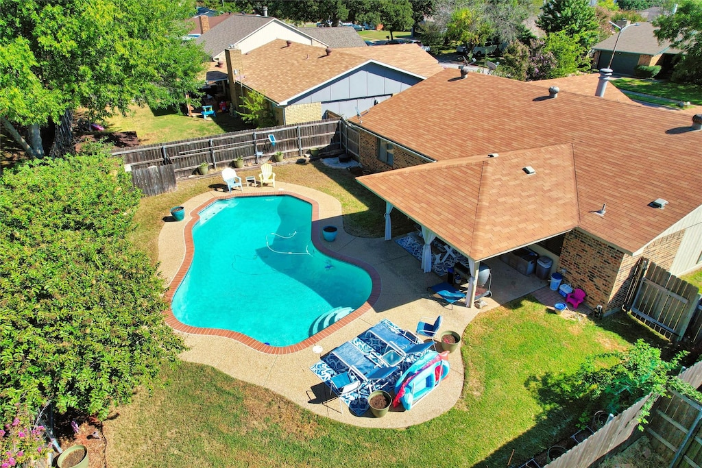 view of pool with a lawn and a patio area