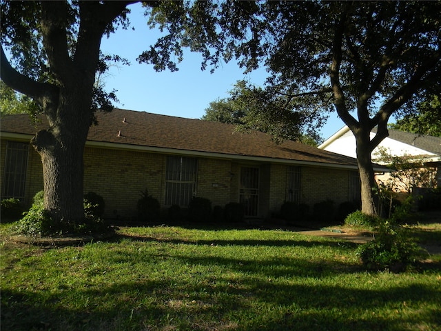 view of side of property with a yard