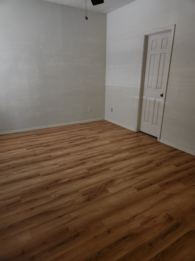 empty room featuring wood-type flooring and ceiling fan