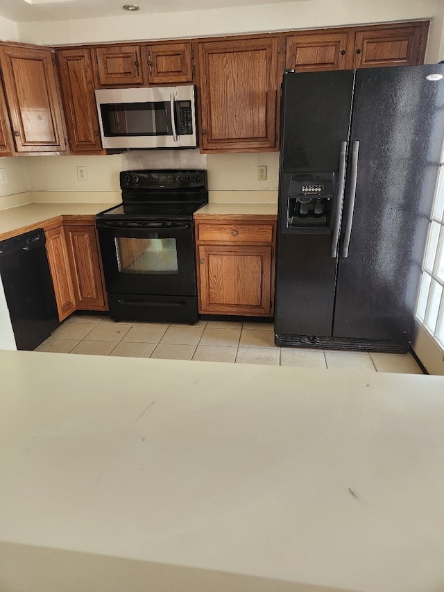 kitchen featuring black appliances and light tile patterned floors