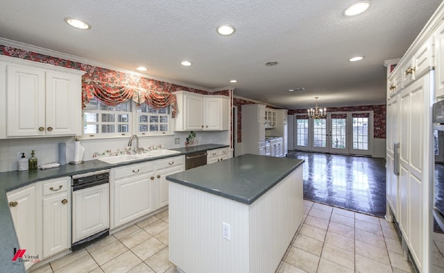 kitchen featuring ornamental molding, white cabinetry, a kitchen island, and sink