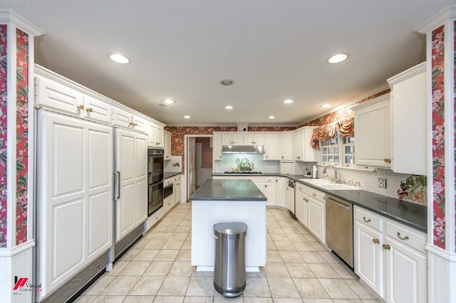 kitchen featuring sink, stainless steel dishwasher, white cabinetry, a center island, and gas stovetop