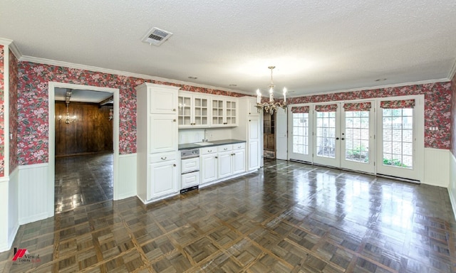 kitchen featuring white cabinetry, dark parquet floors, a textured ceiling, an inviting chandelier, and decorative light fixtures