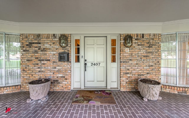 view of exterior entry featuring a porch