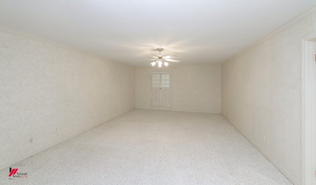 empty room featuring crown molding, carpet flooring, and ceiling fan