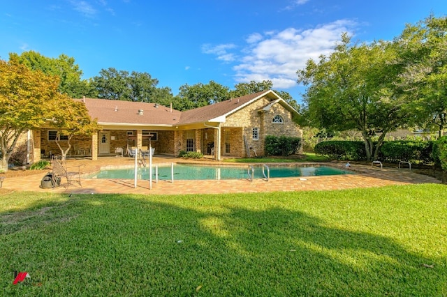 view of pool with a lawn and a patio area