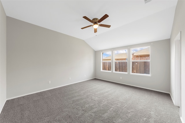 unfurnished room with ceiling fan, carpet floors, and vaulted ceiling