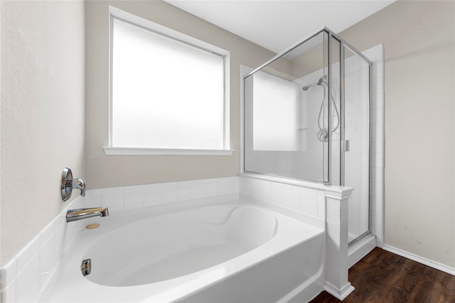 bathroom featuring separate shower and tub and hardwood / wood-style floors