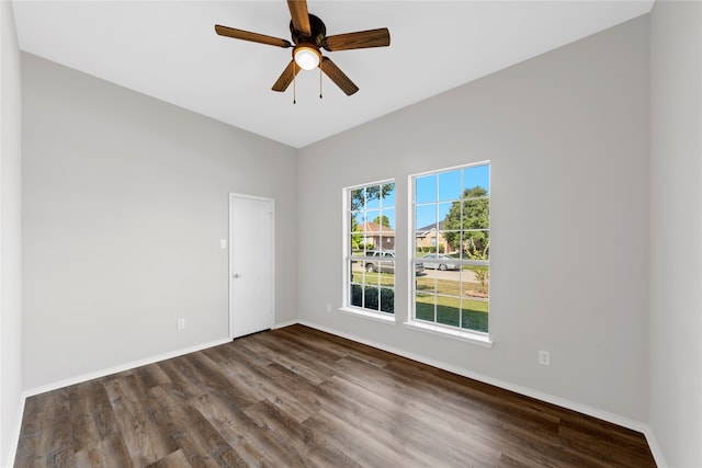 unfurnished room with dark hardwood / wood-style flooring and ceiling fan