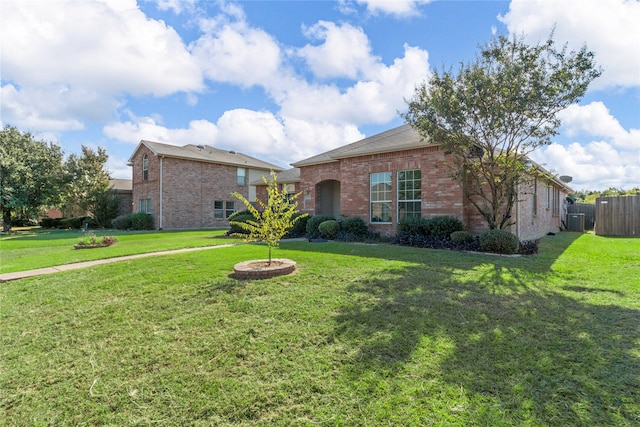 single story home with a front lawn