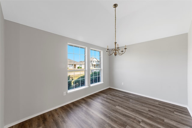 unfurnished dining area with dark hardwood / wood-style floors and a chandelier