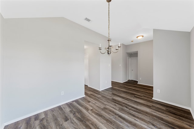 unfurnished dining area with dark wood-type flooring, vaulted ceiling, and an inviting chandelier