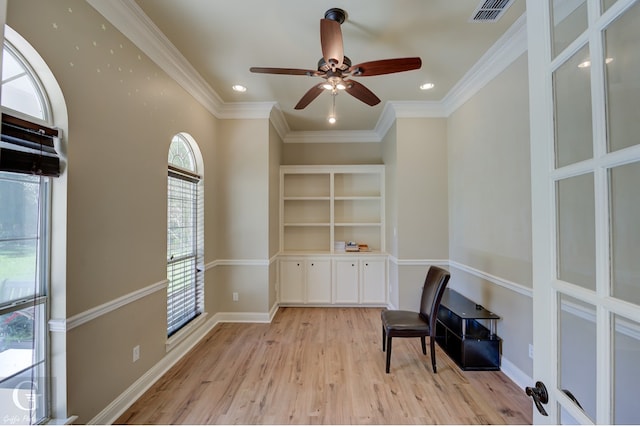 living area featuring light hardwood / wood-style floors, ornamental molding, ceiling fan, and plenty of natural light