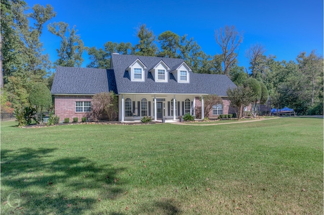 cape cod house with a porch and a front lawn