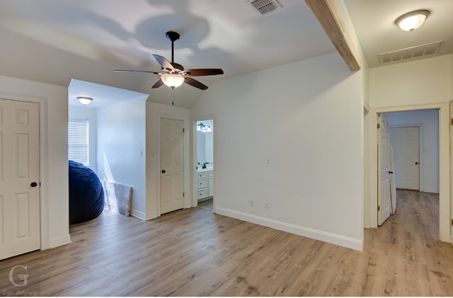 unfurnished room with light wood-type flooring, vaulted ceiling with beams, and ceiling fan