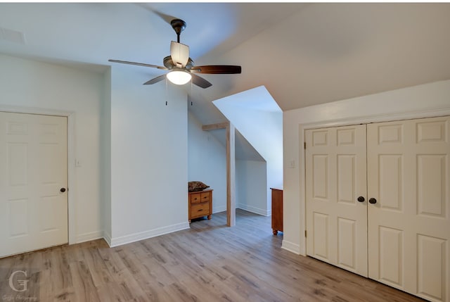 additional living space featuring light wood-type flooring, lofted ceiling, and ceiling fan