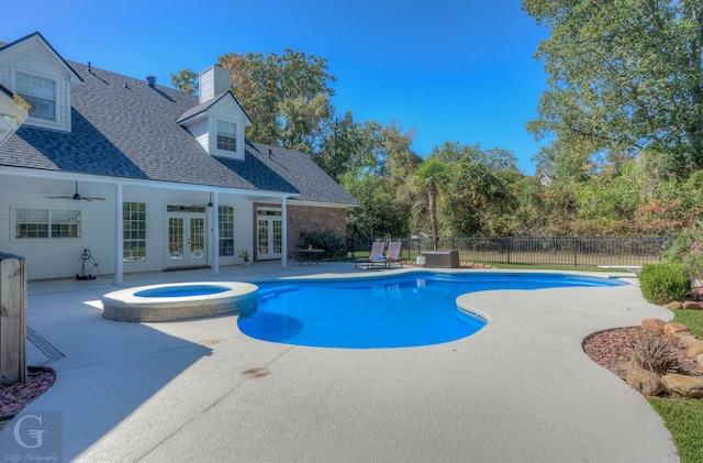 view of pool with ceiling fan, a patio, french doors, and an in ground hot tub