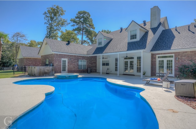 view of pool with ceiling fan, an in ground hot tub, a patio area, and french doors