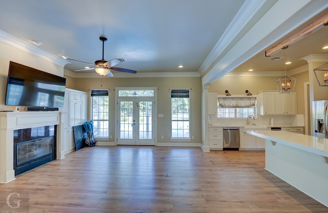 kitchen featuring ornamental molding, light hardwood / wood-style floors, white cabinetry, and dishwasher