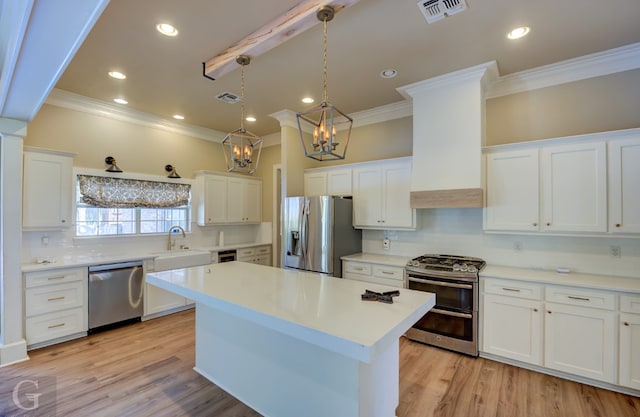 kitchen featuring appliances with stainless steel finishes, light wood-type flooring, and white cabinetry