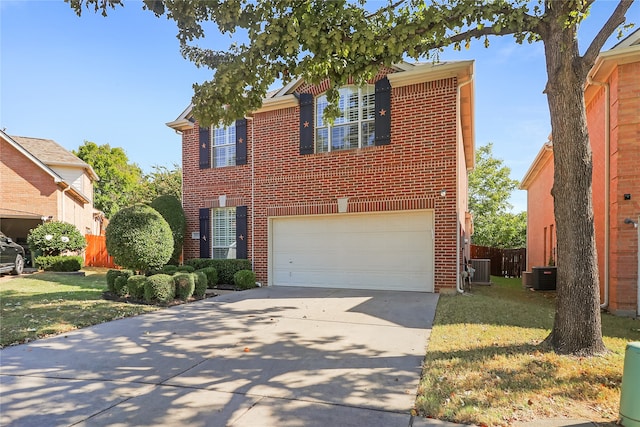 front of property featuring a front lawn, central AC unit, and a garage