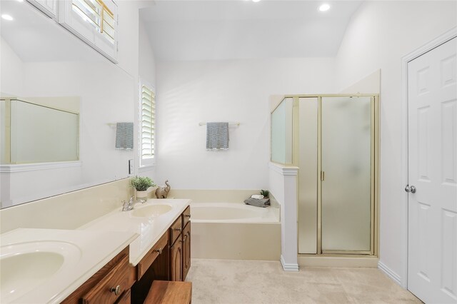 bathroom featuring vanity and shower with separate bathtub