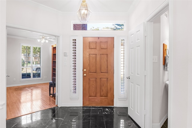 foyer featuring crown molding, ceiling fan, and dark hardwood / wood-style flooring