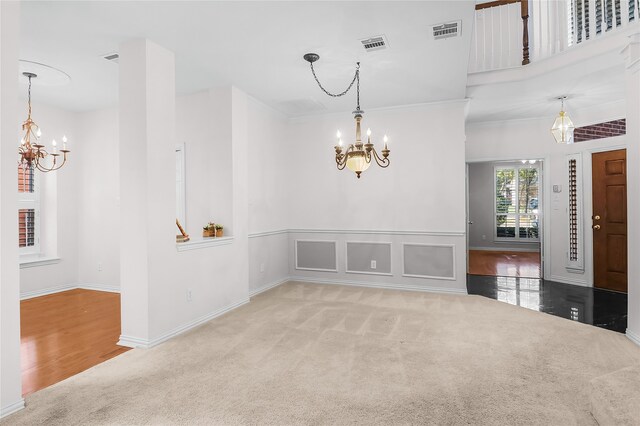 empty room featuring a notable chandelier and wood-type flooring