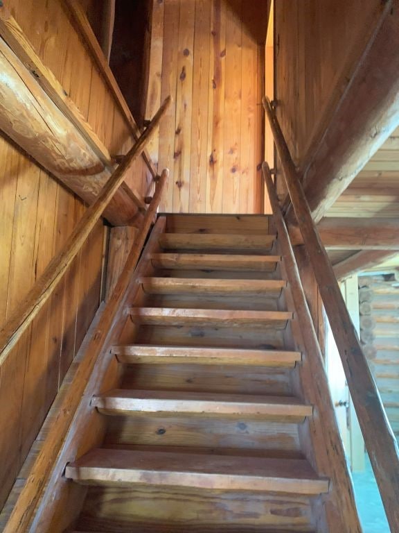 stairway with wooden walls