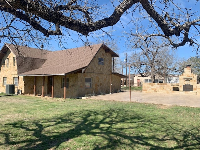 exterior space with cooling unit and a yard