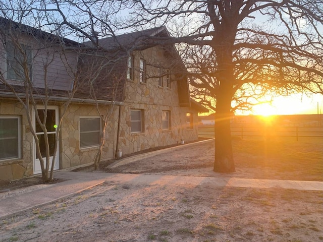 view of back house at dusk