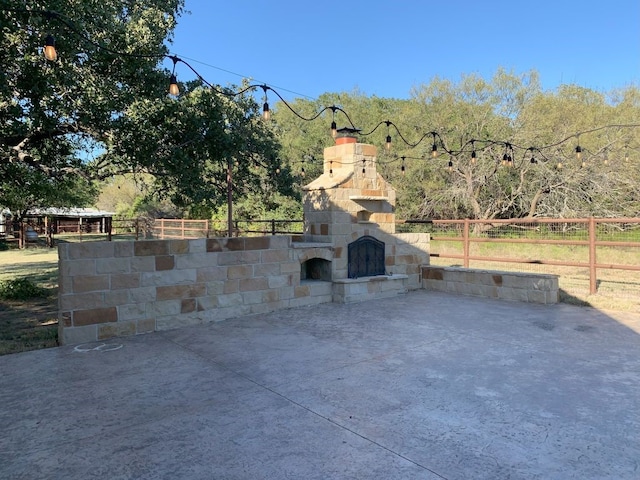 view of patio / terrace with an outdoor stone fireplace