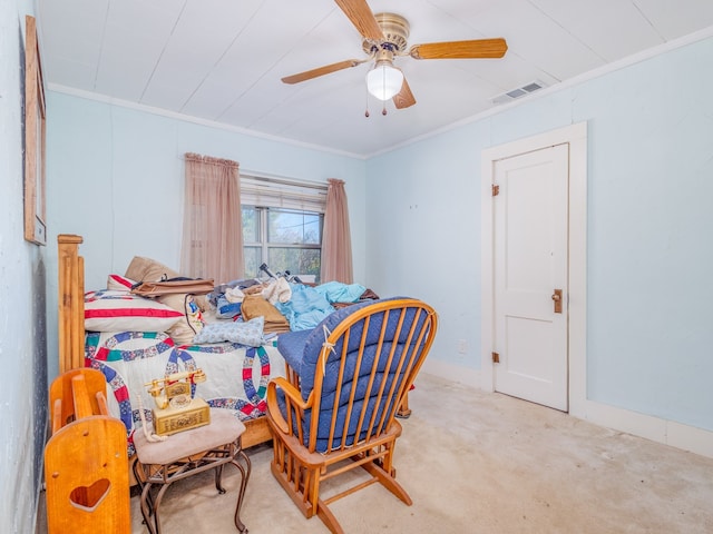 carpeted bedroom featuring crown molding and ceiling fan