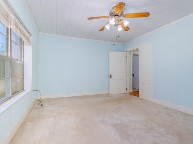 spare room with ceiling fan, light colored carpet, and crown molding