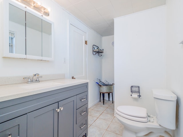 bathroom featuring tile patterned floors, vanity, and toilet