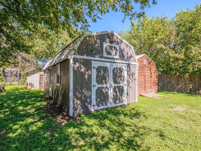 view of outbuilding featuring a lawn