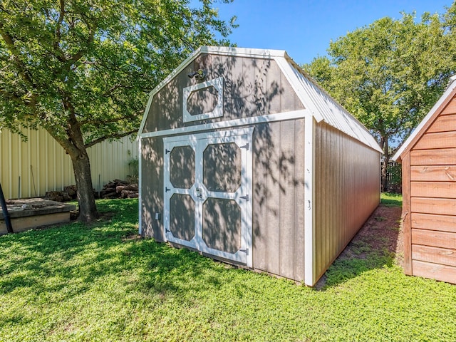 view of outbuilding with a yard