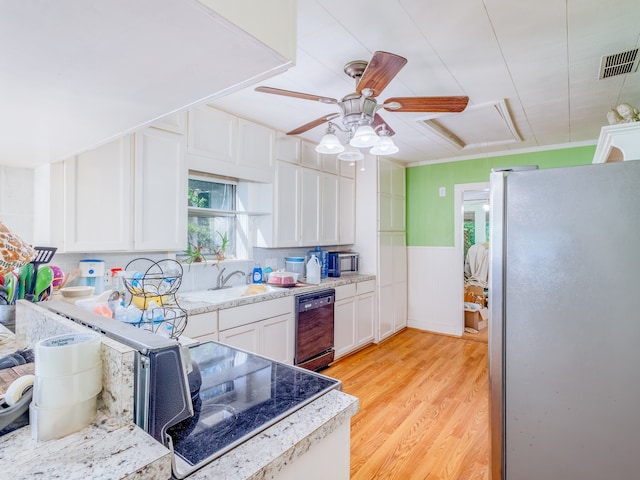 kitchen featuring light wood-type flooring, black dishwasher, white cabinetry, and stainless steel fridge