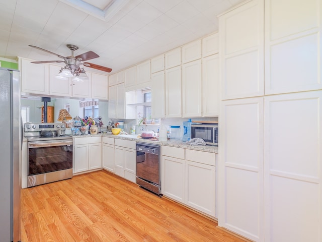 kitchen with appliances with stainless steel finishes, light stone counters, white cabinets, ceiling fan, and light hardwood / wood-style flooring