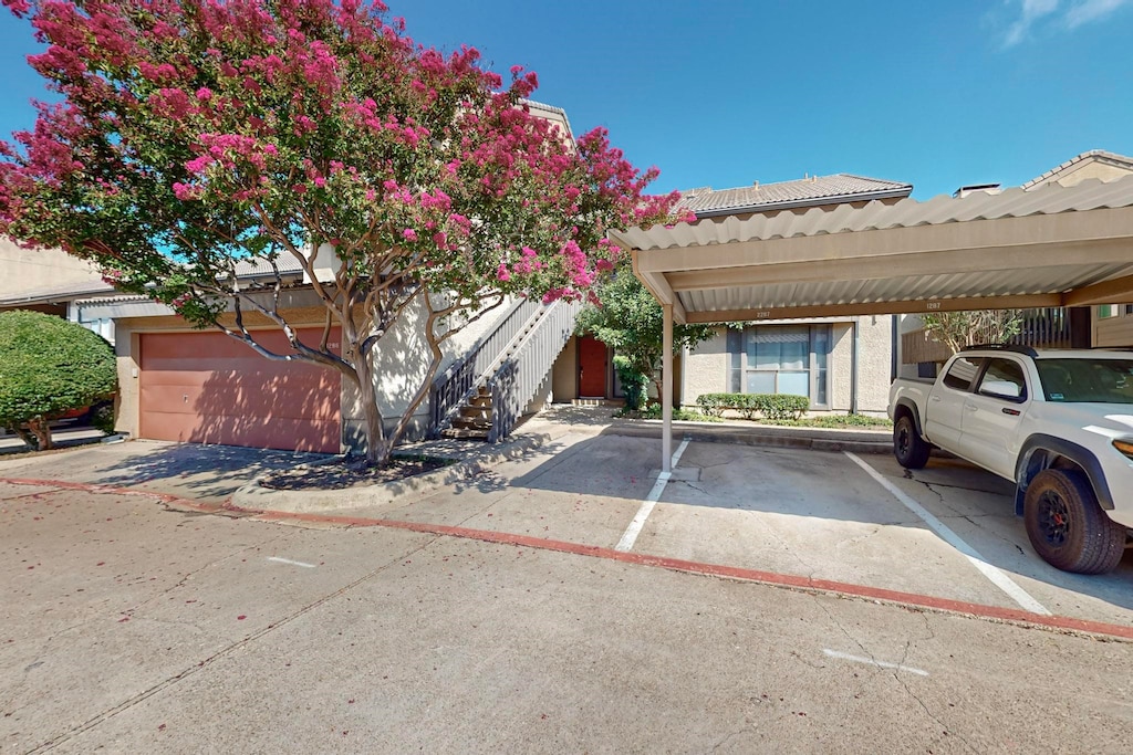 view of front of home featuring a garage and a carport