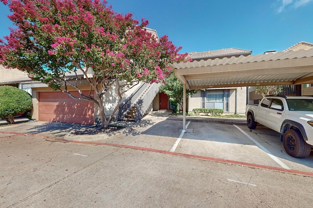 view of front of home featuring a garage and a carport