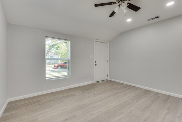 unfurnished room with ceiling fan, vaulted ceiling, and light hardwood / wood-style flooring