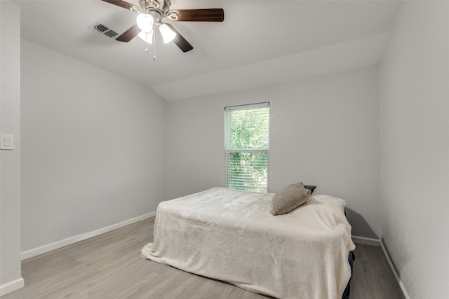 bedroom with ceiling fan, wood-type flooring, and lofted ceiling