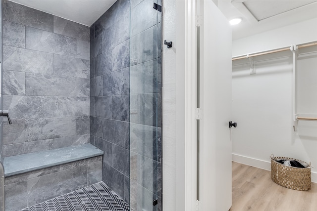 bathroom featuring tiled shower and hardwood / wood-style floors