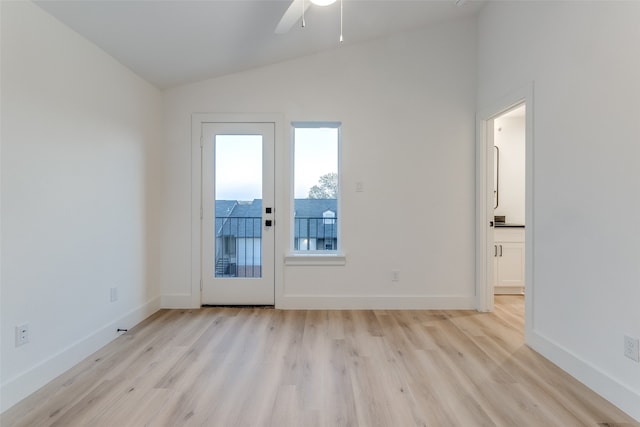 empty room with vaulted ceiling, light hardwood / wood-style floors, and ceiling fan