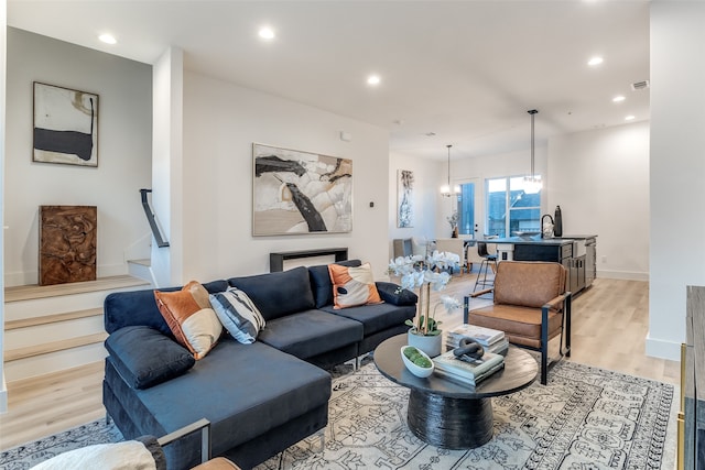 living room featuring light hardwood / wood-style flooring and a chandelier