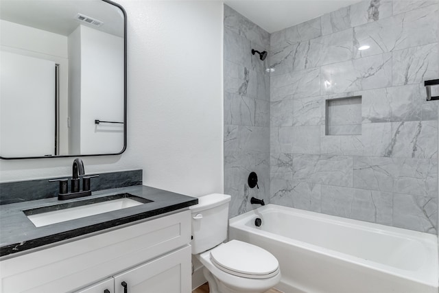 full bathroom with vanity, toilet, and tiled shower / bath